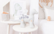 Load image into Gallery viewer, RubyBabyDesigns Keepsake Collective Heirloom Cloth Duke the Dinosaur Keepsake decor. White base with grey etched print, with co-ordinating grey felt spots, and silver faux leather dinosaur spines. Bought to life using environmentally friendly PET fill and wooden buttons on his legs. Designed and handmade in Melbourne.