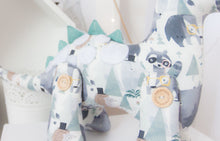 Load image into Gallery viewer, RubyBabyDesigns Heirloom Cloth Decor Duke the Dinosaur, featuring lovely faux leather spines in a seafoam teal, with white wool felt applique spots on his back. His print is a gorgeous watercolour print of blues, navys, seafoams and mochas and features bears, woodlands, mountains and racoons. Filled with environmentally friendly PET fill and jointed together using engraved handmade wooden buttons.Handmade in Melbourne. 